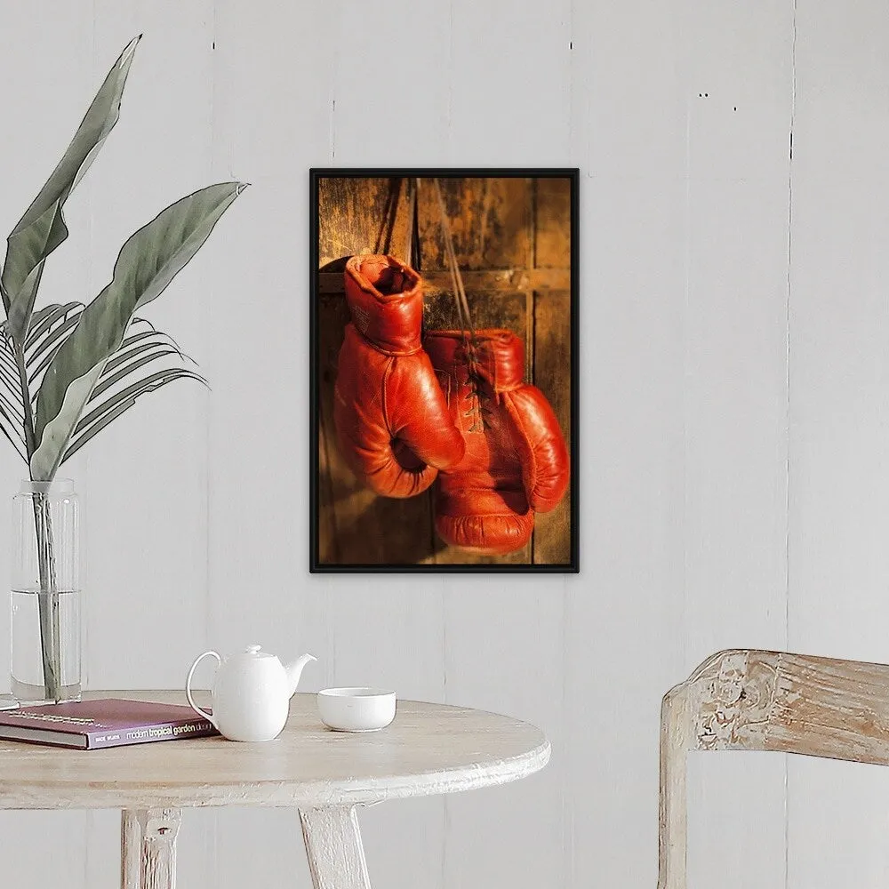 "Boxing gloves hanging on rustic wooden wall" Black Float Frame Canvas Art